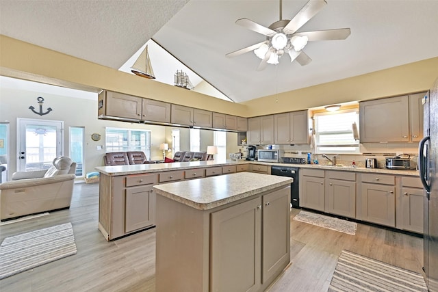206 Galleon Dr, Freeport, TX 77541 - kitchen with open floor plan, a peninsula, black dishwasher, gray cabinets, and high vaulted ceiling