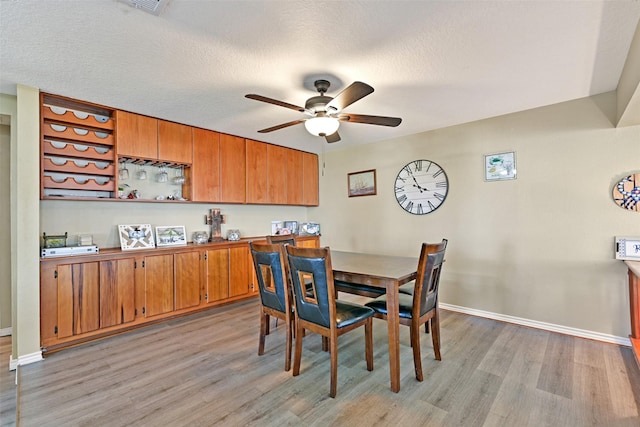 206 Galleon Dr, Freeport, TX 77541 - dining area featuring light wood-style floors, ceiling fan, and a textured ceiling
