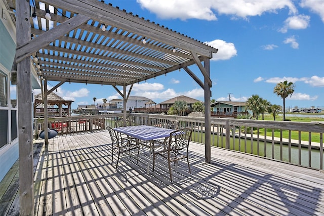 206 Galleon Dr, Freeport, TX 77541 - wooden terrace featuring a pergola, outdoor dining area, a residential view, and a water view