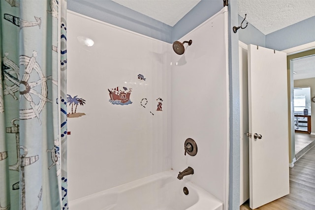 206 Galleon Dr, Freeport, TX 77541 - full bath with shower / tub combo, wood finished floors, and a textured ceiling