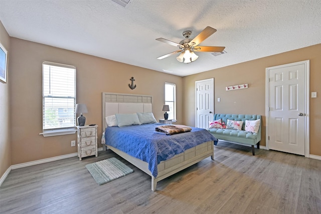 206 Galleon Dr, Freeport, TX 77541 - bedroom with wood finished floors, a textured ceiling, and ceiling fan