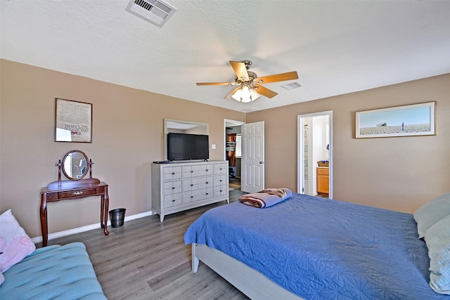 206 Galleon Dr, Freeport, TX 77541 - bedroom with wood finished floors, ceiling fan, and connected bathroom