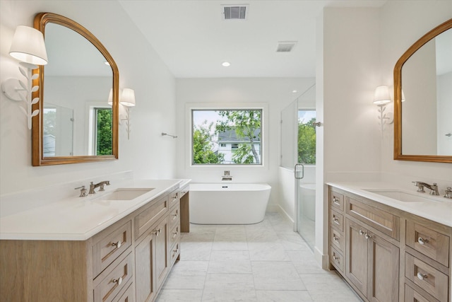 2006 Chantilly Ln, Houston, TX 77018 - full bath featuring two vanities, a freestanding bath, marble finish flooring, and a shower