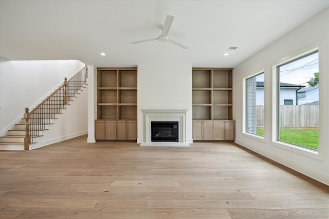 2006 Chantilly Ln, Houston, TX 77018 - unfurnished living room with built in shelves, stairway, light wood-style floors, and recessed lighting