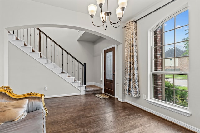 18514 Providence Landing Ln, Richmond, TX 77407 - foyer entrance featuring wood finished floors, healthy amount of natural light, a chandelier, and arched walkways
