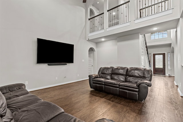 18514 Providence Landing Ln, Richmond, TX 77407 - living area with a towering ceiling, wood finished floors, and arched walkways
