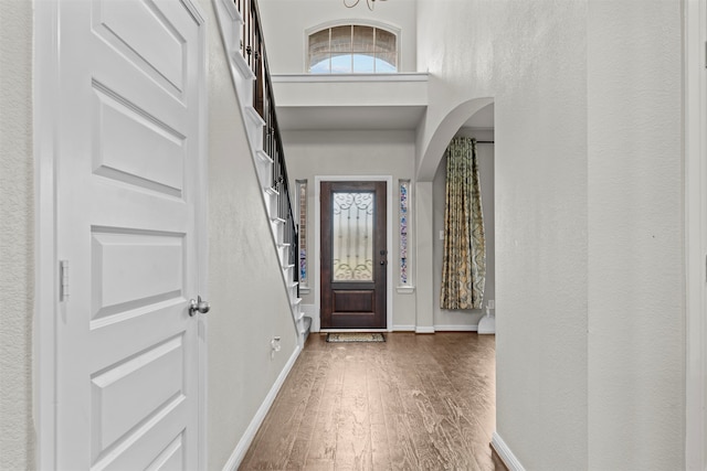 18514 Providence Landing Ln, Richmond, TX 77407 - entrance foyer featuring wood finished floors, plenty of natural light, arched walkways, and a high ceiling
