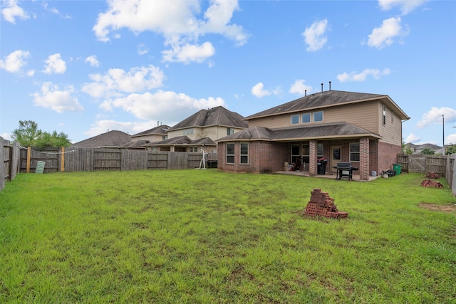 18514 Providence Landing Ln, Richmond, TX 77407 - rear view of house featuring brick siding, a fenced backyard, and a patio