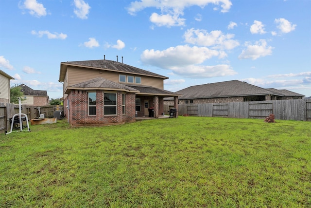 18514 Providence Landing Ln, Richmond, TX 77407 - rear view of property featuring brick siding, a fenced backyard, and a patio area