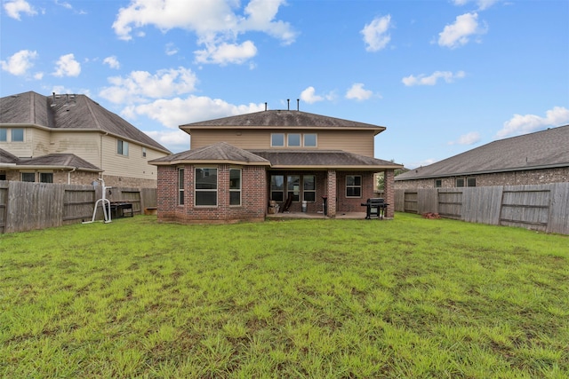 18514 Providence Landing Ln, Richmond, TX 77407 - rear view of property with brick siding, a fenced backyard, and a patio