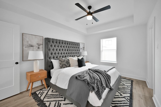 8019 Cora St, Houston, TX 77088 - bedroom with a tray ceiling, light wood finished floors, and ceiling fan