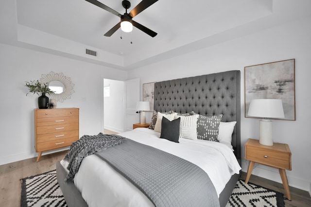 8019 Cora St, Houston, TX 77088 - bedroom featuring a raised ceiling, wood finished floors, and a ceiling fan
