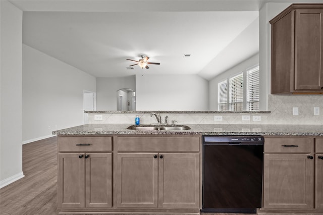 132 Big Sandy Ln, Anahuac, TX 77514 - kitchen featuring black dishwasher, a ceiling fan, light stone counters, decorative backsplash, and lofted ceiling