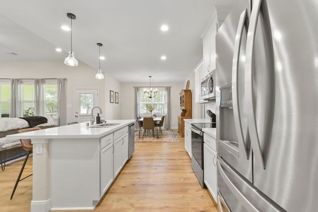 16003 Westward Ho St, Stagecoach, TX 77355 - kitchen with stainless steel appliances, light wood-style floors, light countertops, white cabinets, and recessed lighting