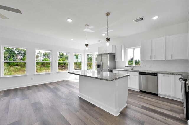 1089 Rd 5740, Cleveland, TX 77327 - kitchen with appliances with stainless steel finishes, light stone countertops, recessed lighting, a kitchen island, and white cabinets