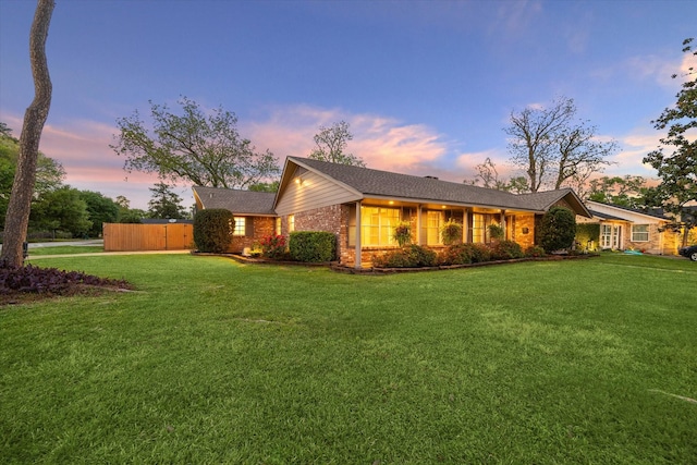 9222 Bronco Dr, Houston, TX 77055 - ranch-style house featuring a front lawn and brick siding