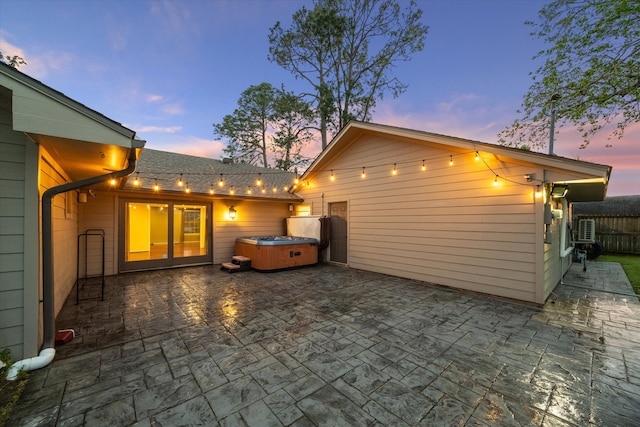 9222 Bronco Dr, Houston, TX 77055 - back of house featuring a hot tub and a patio area
