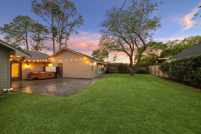 9222 Bronco Dr, Houston, TX 77055 - yard at dusk featuring a hot tub, a patio area, and a fenced backyard