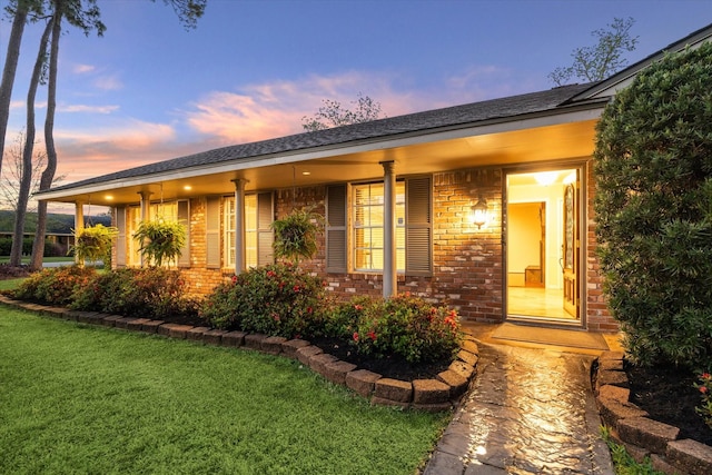 9222 Bronco Dr, Houston, TX 77055 - view of front facade with brick siding, a front yard, and covered porch