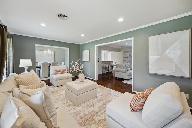 9222 Bronco Dr, Houston, TX 77055 - living room with wood finished floors, a chandelier, crown molding, and recessed lighting