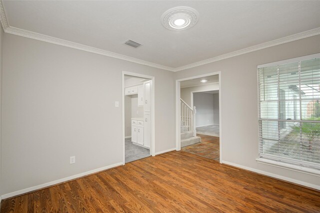 5330 Boyce Springs Dr, Houston, TX 77066 - empty room with crown molding, stairway, and wood finished floors