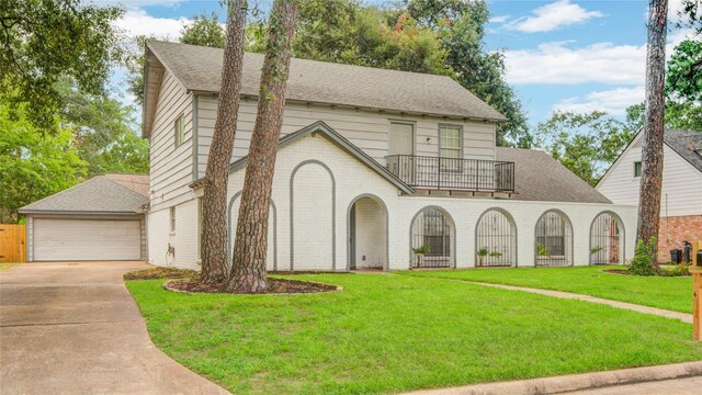 5330 Boyce Springs Dr, Houston, TX 77066 - view of front of home with a balcony, brick siding, a shingled roof, a front lawn, and a garage