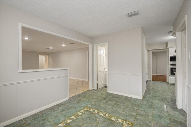 5330 Boyce Springs Dr, Houston, TX 77066 - empty room with recessed lighting, a textured ceiling, and a wainscoted wall