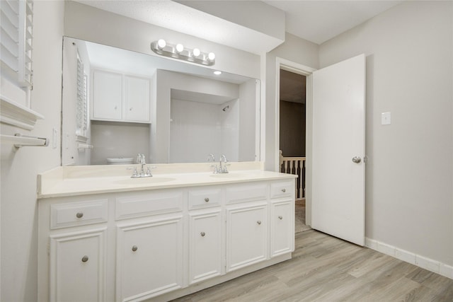 5330 Boyce Springs Dr, Houston, TX 77066 - full bathroom with double vanity and wood finished floors