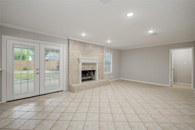 5330 Boyce Springs Dr, Houston, TX 77066 - unfurnished living room with ornamental molding, healthy amount of natural light, recessed lighting, french doors, and light tile patterned floors