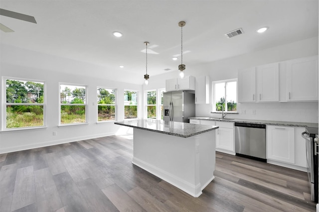 1449 Rd 5734, Cleveland, TX 77327 - kitchen with appliances with stainless steel finishes, light stone countertops, recessed lighting, a kitchen island, and white cabinets