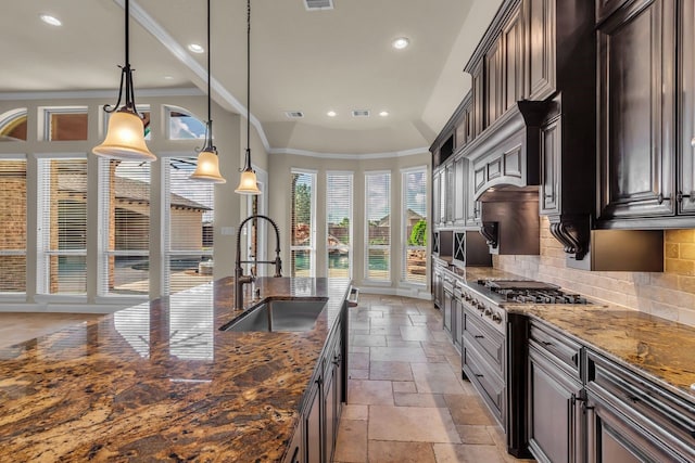 20307 Knights Branch Dr, Cypress, TX 77433 - kitchen with stone tile flooring, stainless steel gas stovetop, recessed lighting, tasteful backsplash, and dark stone counters