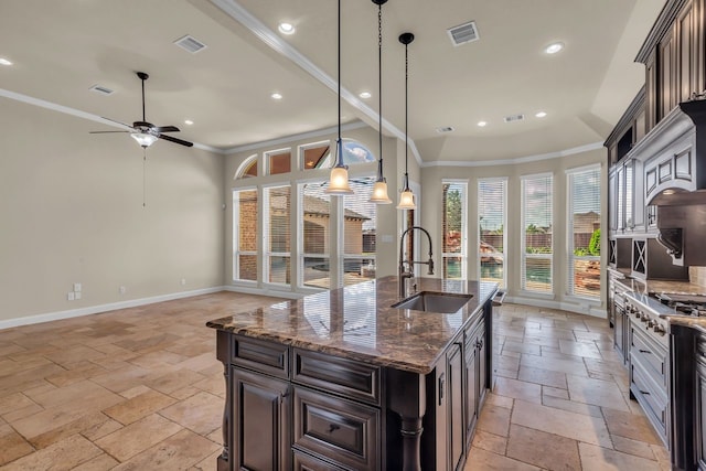 20307 Knights Branch Dr, Cypress, TX 77433 - kitchen with stone tile floors, stainless steel gas stovetop, ornamental molding, recessed lighting, and ceiling fan