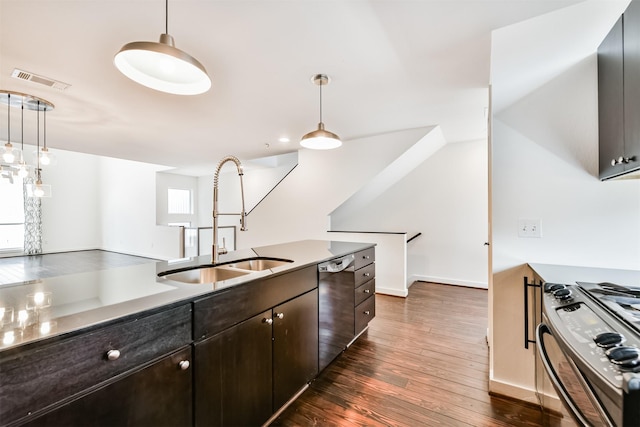 3028 Commerce St, Houston, TX 77003 - kitchen featuring stainless steel appliances, dark wood finished floors, hanging light fixtures, and dark brown cabinetry