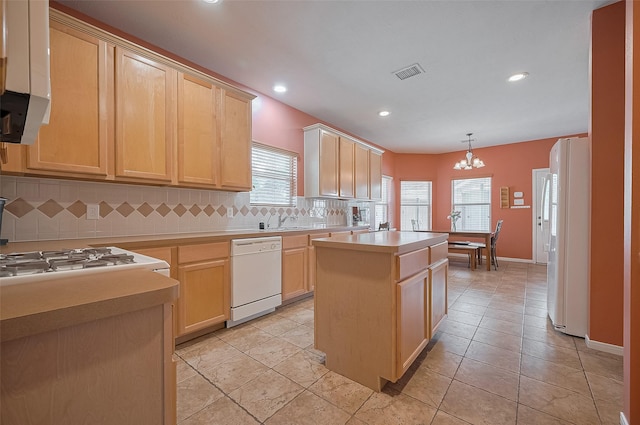 24922 Falcon Hollow Ln, Katy, TX 77494 - kitchen featuring white appliances, light brown cabinets, a center island, tasteful backsplash, and recessed lighting