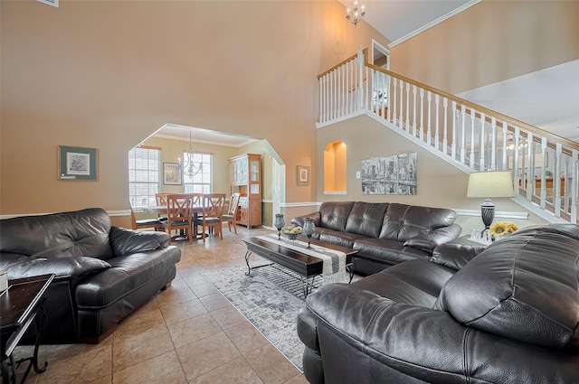 24922 Falcon Hollow Ln, Katy, TX 77494 - living room with a chandelier, stairway, a towering ceiling, arched walkways, and ornamental molding