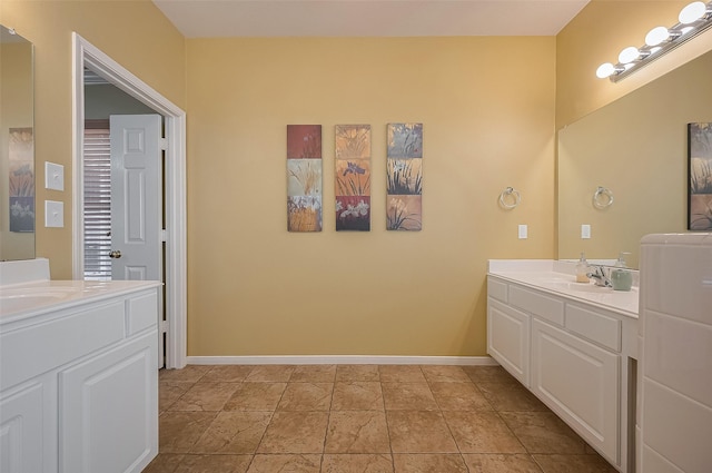 24922 Falcon Hollow Ln, Katy, TX 77494 - full bathroom featuring two vanities and baseboards