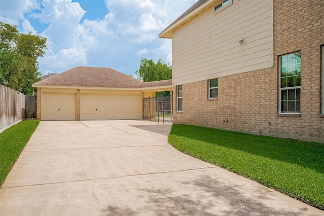 24922 Falcon Hollow Ln, Katy, TX 77494 - view of property exterior featuring driveway, brick siding, and a garage
