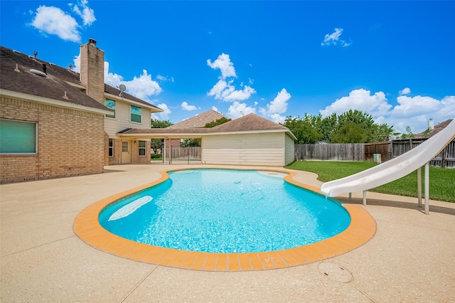 24922 Falcon Hollow Ln, Katy, TX 77494 - view of swimming pool with a water slide, a fenced backyard, and a patio area