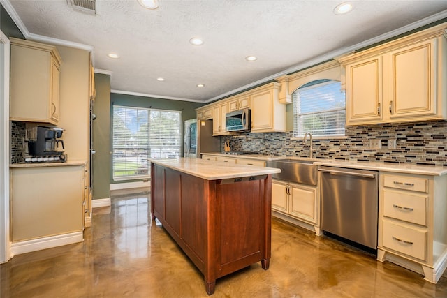 1201 Coryell St, League City, TX 77573 - kitchen featuring stainless steel appliances, concrete floors, crown molding, cream cabinets, and recessed lighting