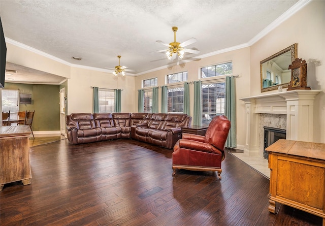 1201 Coryell St, League City, TX 77573 - living room with ceiling fan, wood-type flooring, a fireplace, a textured ceiling, and ornamental molding