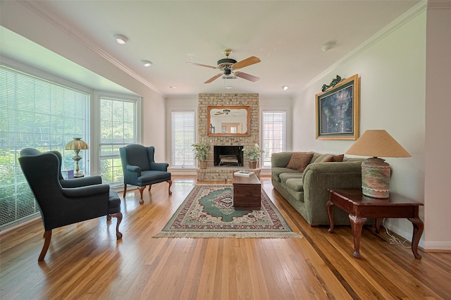 826 Heights Blvd, Houston, TX 77007 - living room featuring ceiling fan, wood finished floors, ornamental molding, and a brick fireplace
