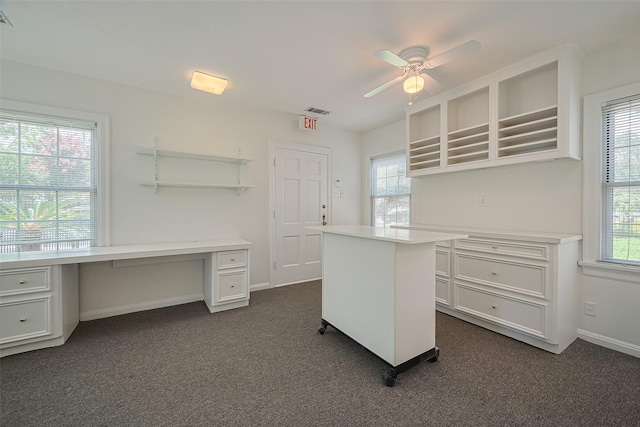 826 Heights Blvd, Houston, TX 77007 - unfurnished office featuring built in study area, ceiling fan, and dark colored carpet