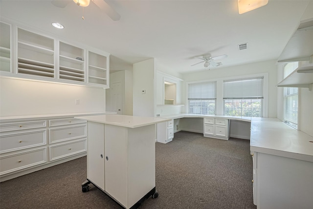 826 Heights Blvd, Houston, TX 77007 - kitchen with ceiling fan, dark colored carpet, and built in desk