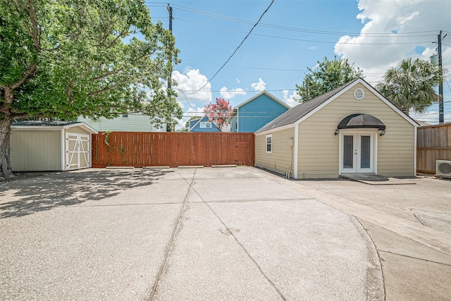 826 Heights Blvd, Houston, TX 77007 - back of property featuring french doors, a storage unit, and a patio area