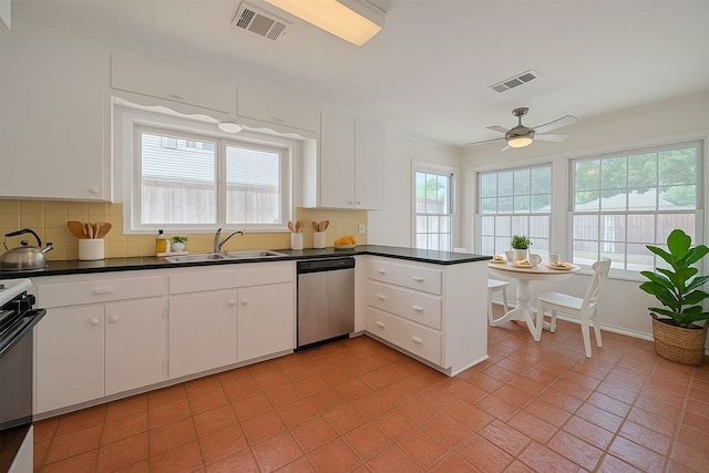 826 Heights Blvd, Houston, TX 77007 - kitchen featuring stainless steel dishwasher, backsplash, and white cabinetry
