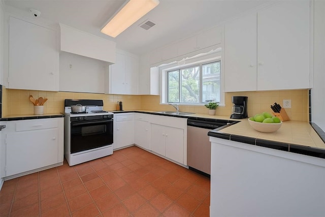 826 Heights Blvd, Houston, TX 77007 - kitchen featuring white gas range, stainless steel dishwasher, tile counters, white cabinetry, and decorative backsplash
