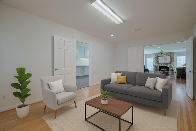 826 Heights Blvd, Houston, TX 77007 - living room featuring light wood-style floors, a large fireplace, and recessed lighting