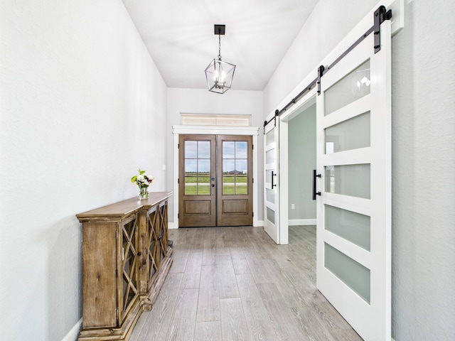 2711 Oakwood Shores Dr, Richwood, TX 77515 - entryway featuring a barn door and light wood-style floors