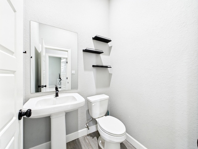 2711 Oakwood Shores Dr, Richwood, TX 77515 - half bathroom featuring wood finished floors and toilet