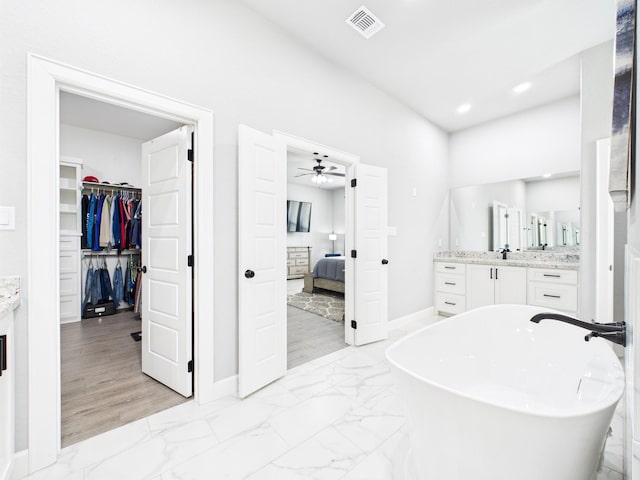 2711 Oakwood Shores Dr, Richwood, TX 77515 - full bath featuring vanity, marble finish floors, a soaking tub, ensuite bathroom, and recessed lighting